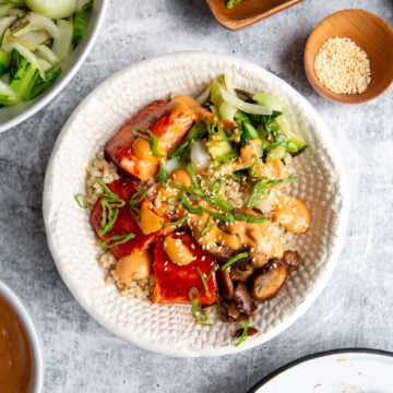 gochujang salmon marinated and cooked then built into a bowl with veggies