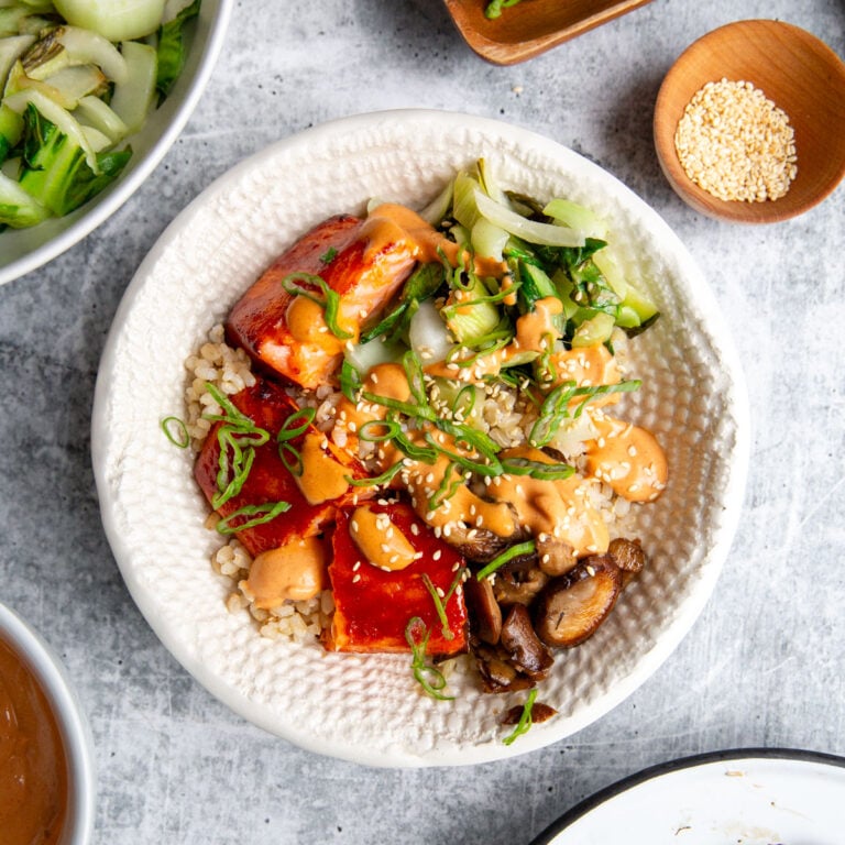 gochujang salmon marinated and cooked then built into a bowl with veggies