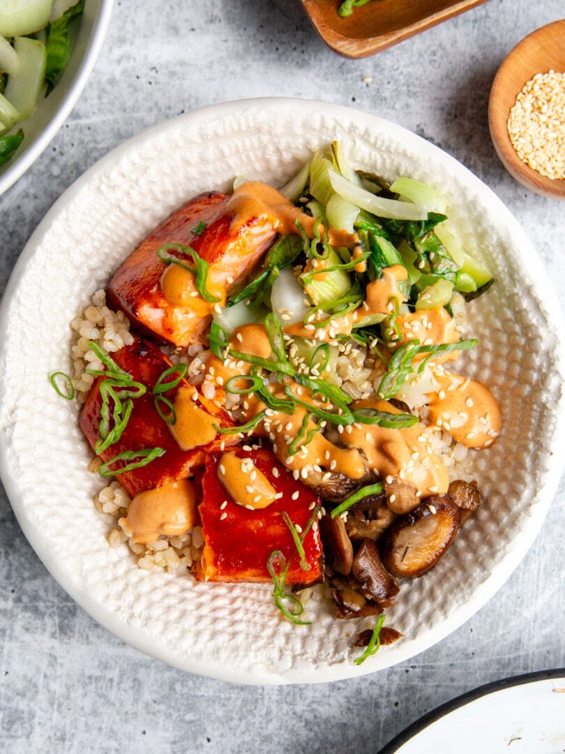 gochujang salmon marinated and cooked then built into a bowl with veggies