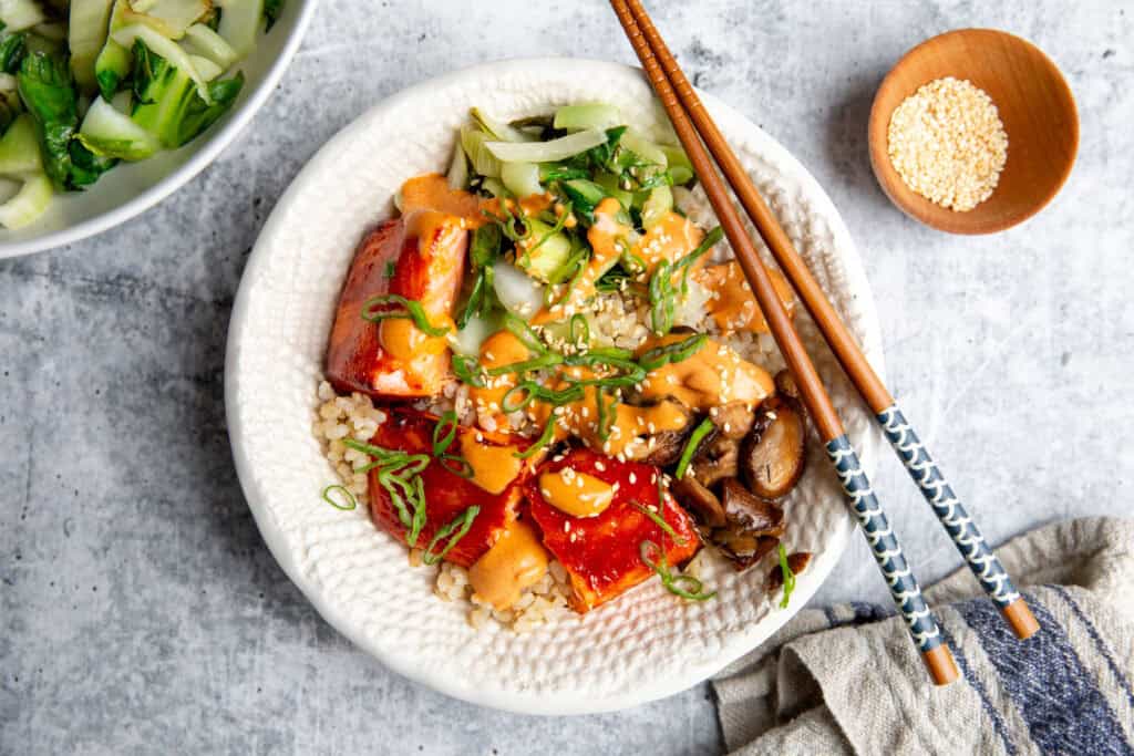gochujang salmon cooked and layered in a delicious bowl with veggies and sauce