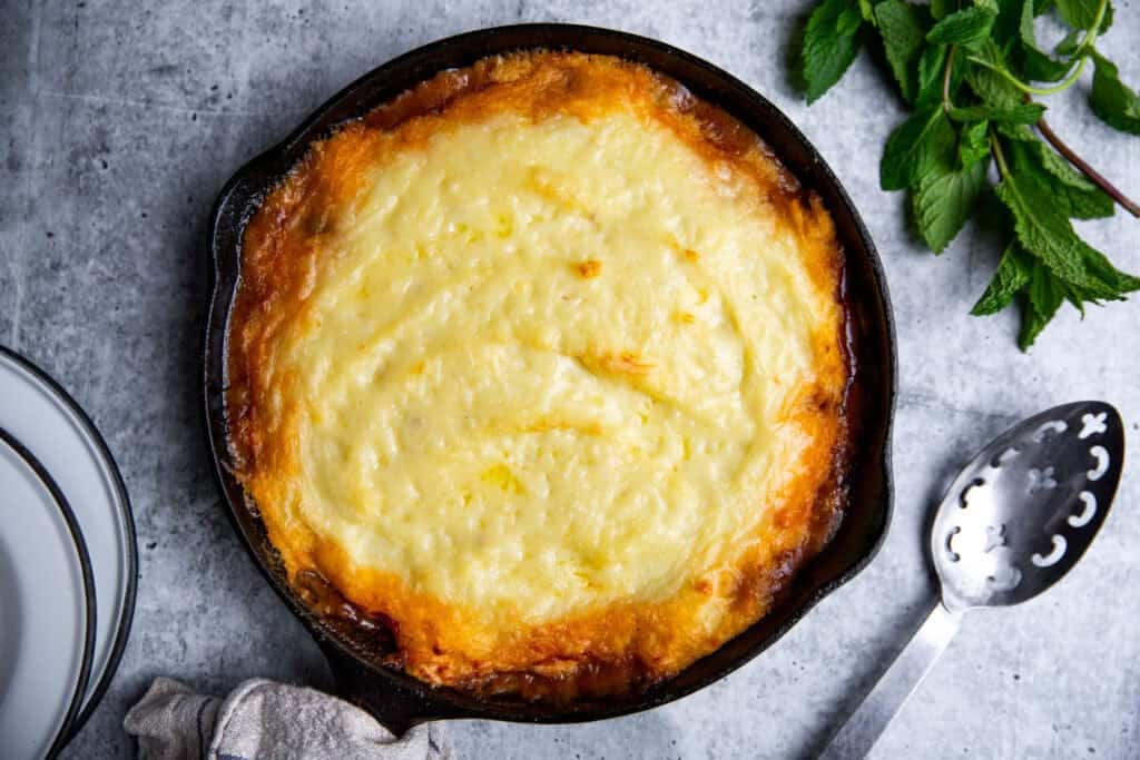 lamb shepherd's pie in a cast iron skillet browned on top