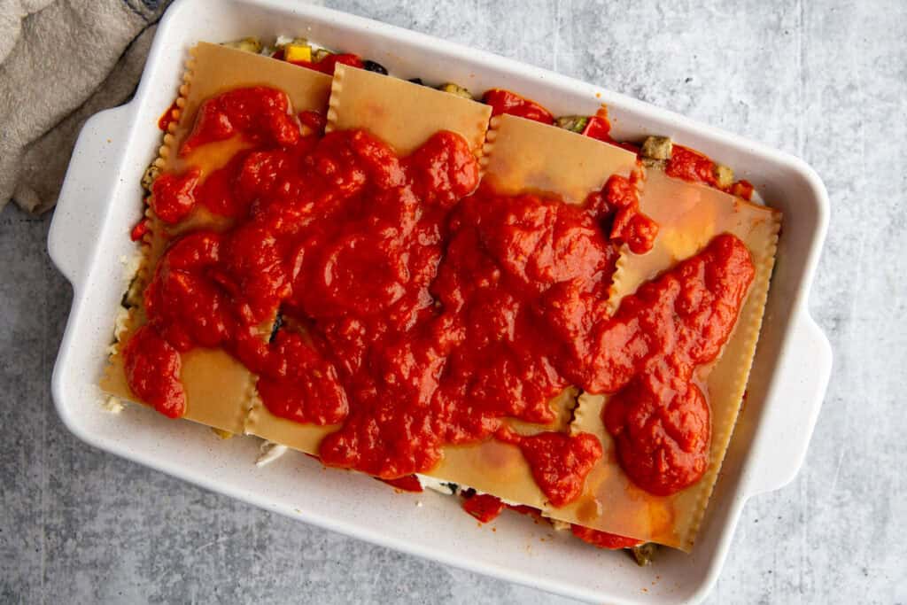 The next layer, with noodles and marinara sauce.