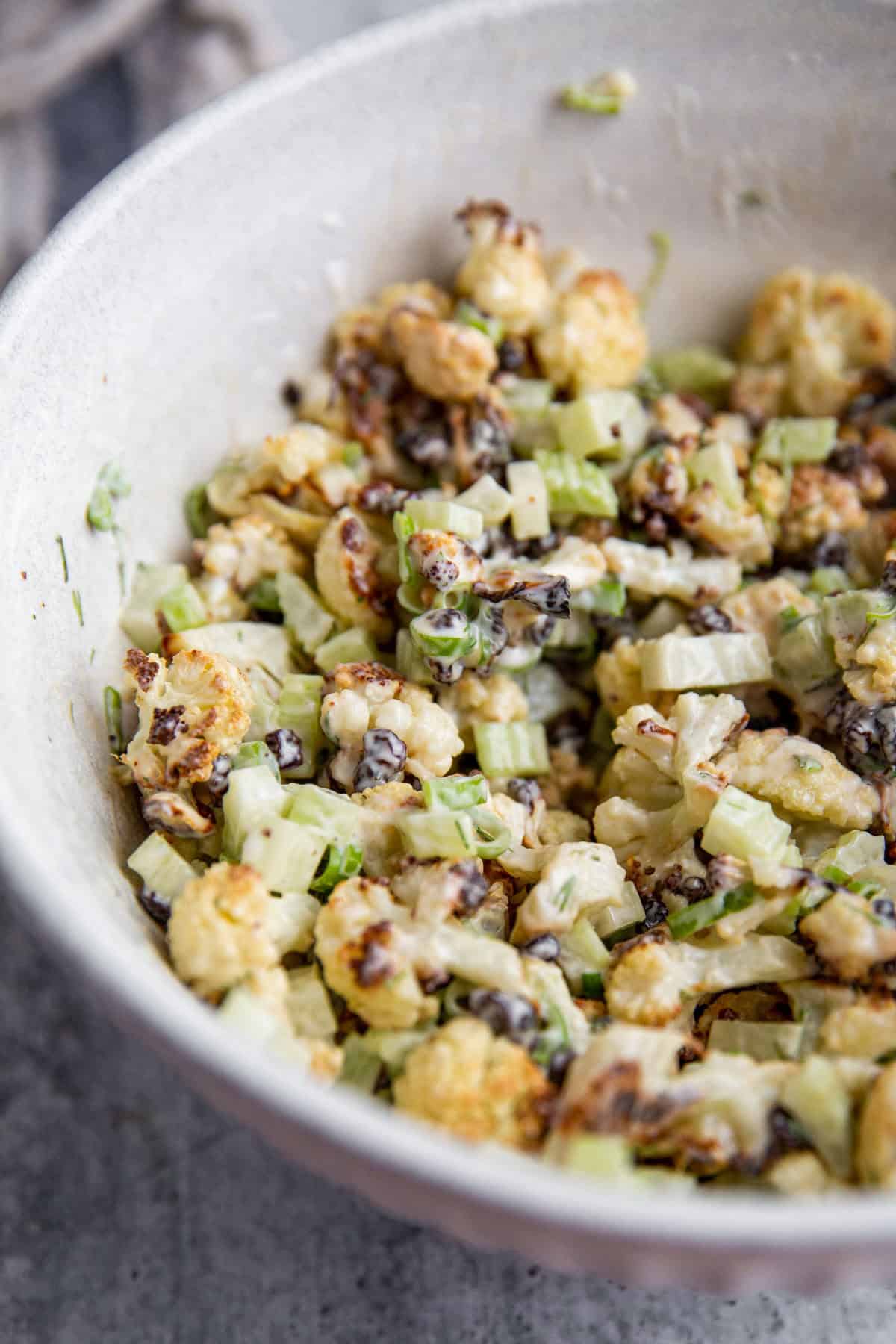 a close up easy roasted cauliflower salad in a bowl