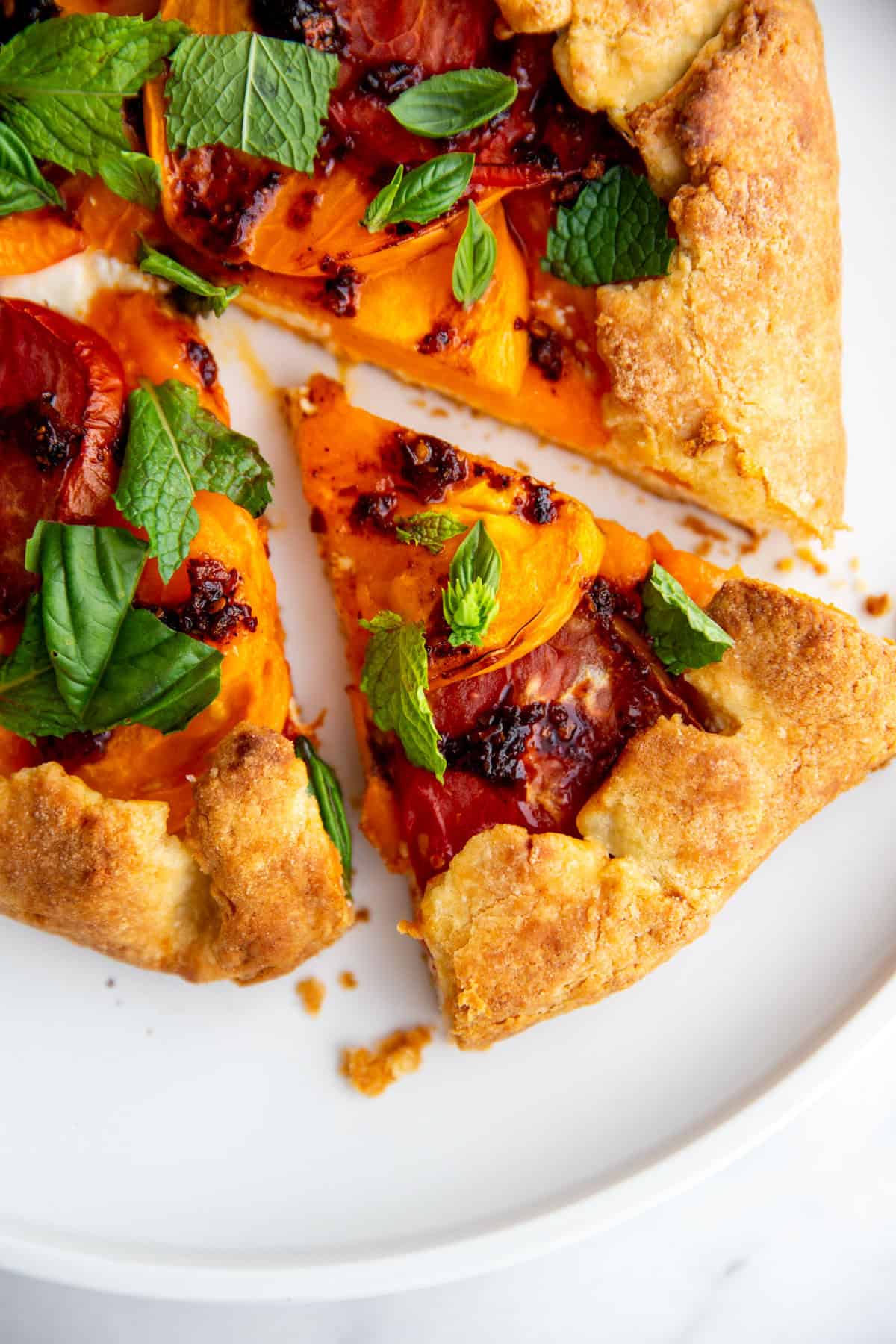 a slice of tomato galette taken out of the whole tart. 