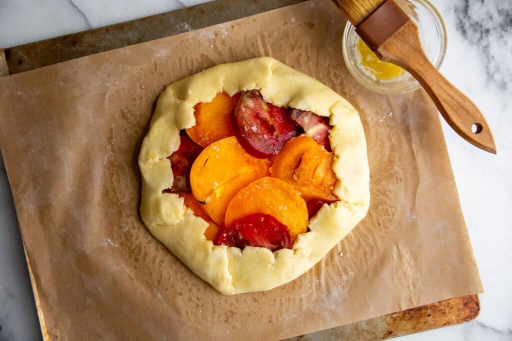 the edges of the tomato galette folded over the tomatoes before baking. 