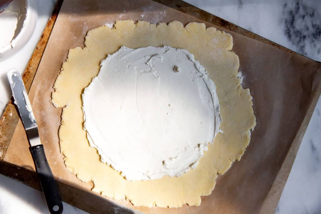 the dough rolled out with a smear of goat cheese on top. 